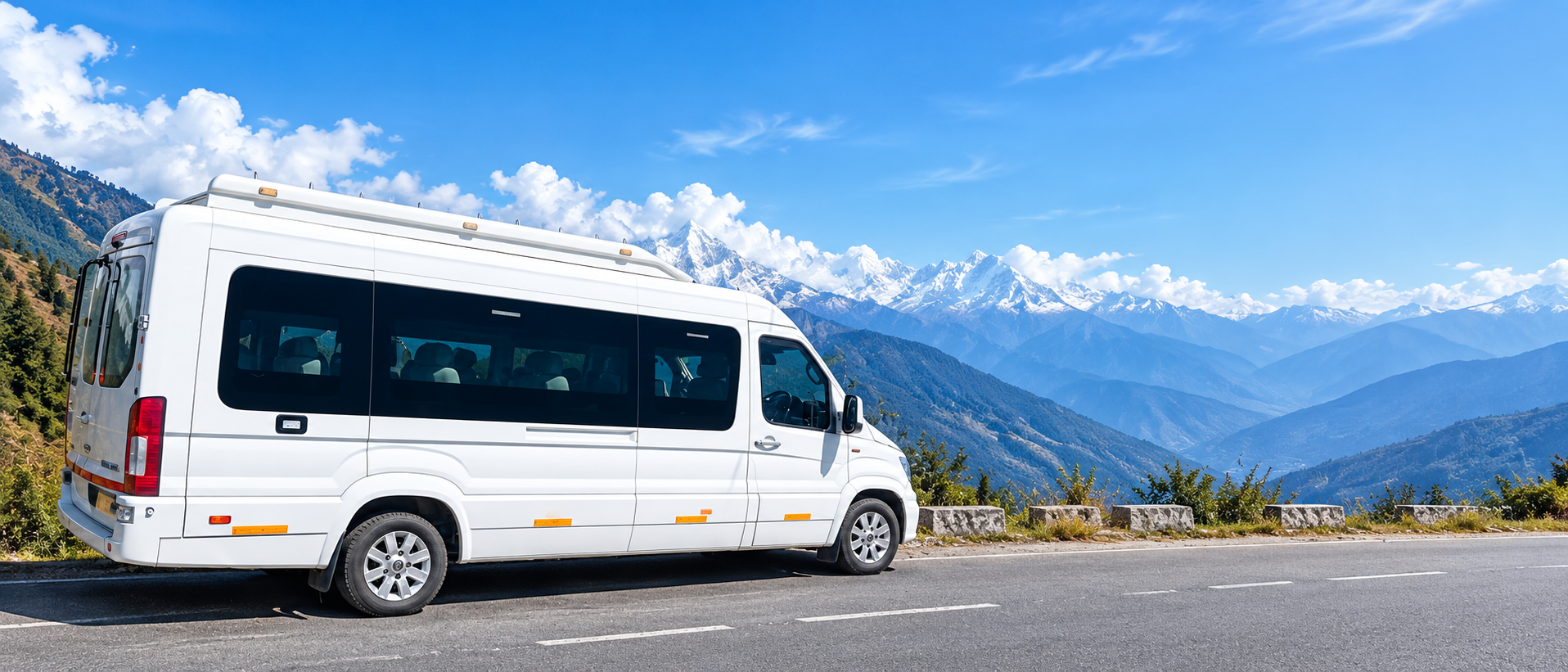White passenger van on a scenic mountain road